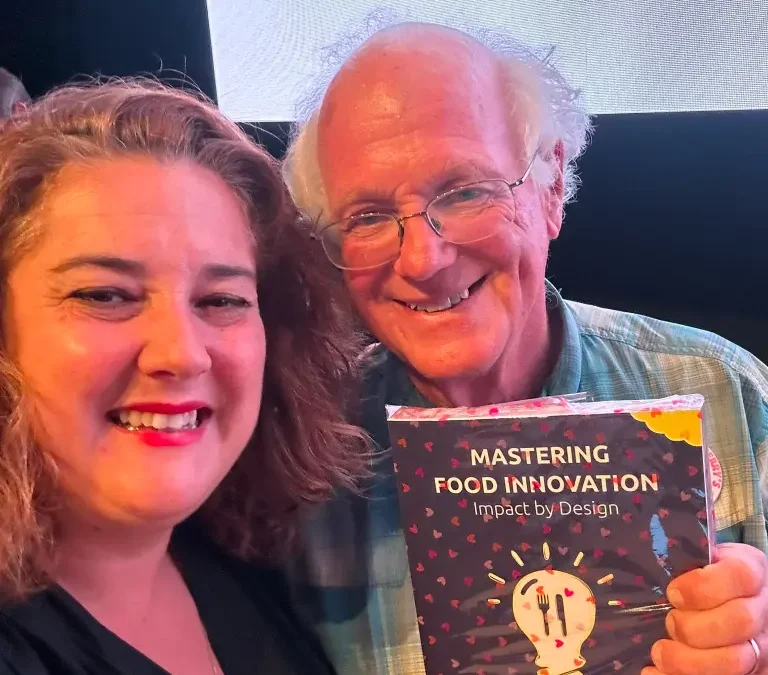 Ben Cohen with Mary van Hoek-Hendriks receiving book Mastering Food Innovation