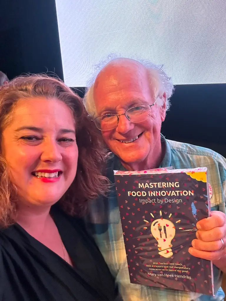 Ben Cohen with Mary van Hoek-Hendriks receiving book Mastering Food Innovation